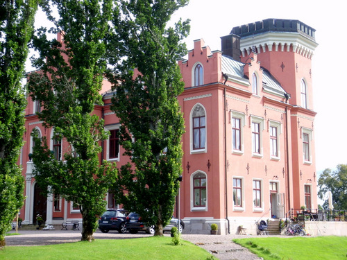 Pink Castle with strollers and bicycles.